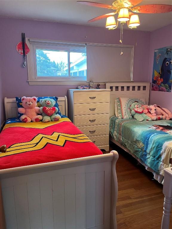 bedroom featuring ceiling fan and dark hardwood / wood-style floors