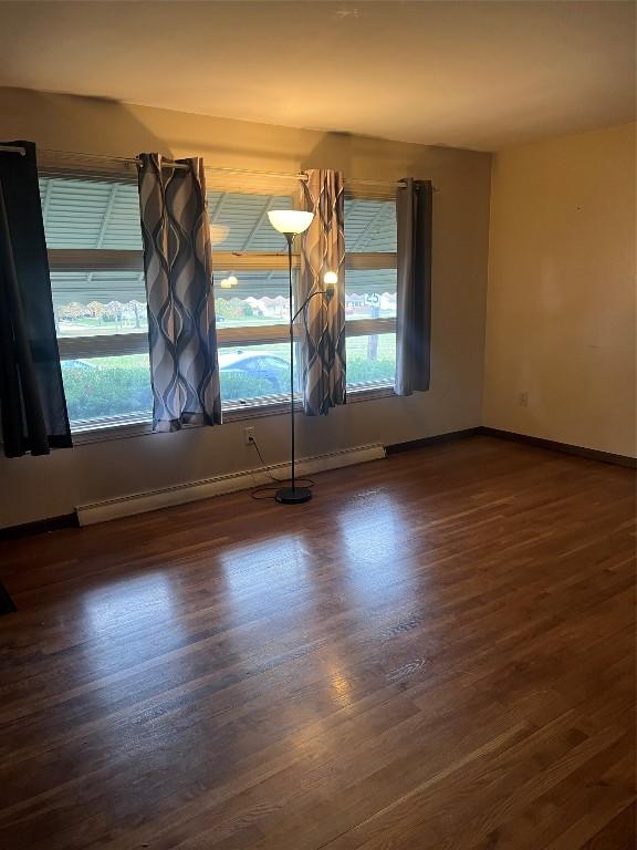 spare room with dark hardwood / wood-style floors