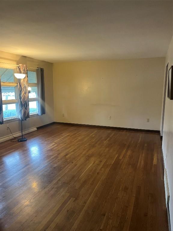 spare room with dark wood-type flooring