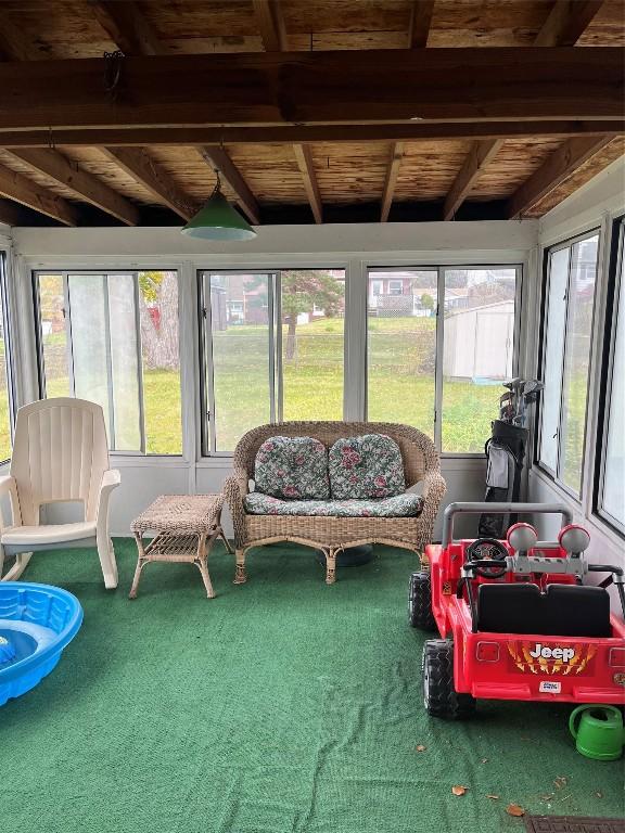 sunroom / solarium with a wealth of natural light, beamed ceiling, and wood ceiling