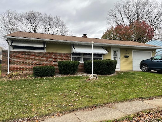 view of front of property with a front yard and a garage