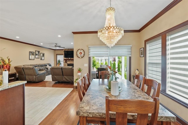 5640 Bear Run Cir, Fairview, PA 16415 - dining room featuring healthy amount of natural light, ornamental molding, wood finished floors, ceiling fan, and a stone fireplace