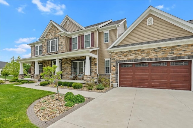 5640 Bear Run Cir, Fairview, PA 16415 - craftsman house with stone siding, covered porch, concrete driveway, and a garage