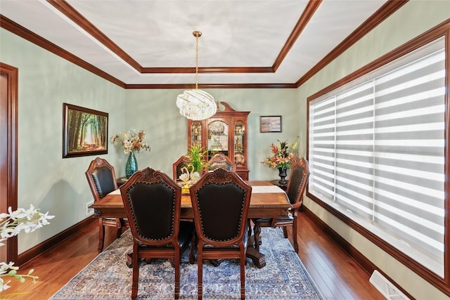 5640 Bear Run Cir, Fairview, PA 16415 - dining room with a chandelier, dark wood-style floors, a raised ceiling, ornamental molding, and baseboards