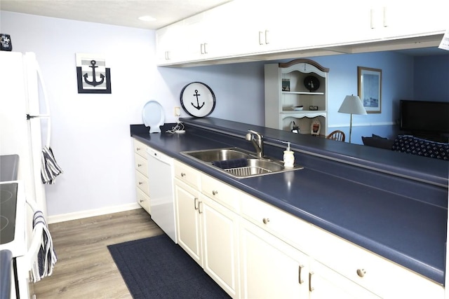 kitchen featuring white cabinetry, sink, white appliances, and hardwood / wood-style floors