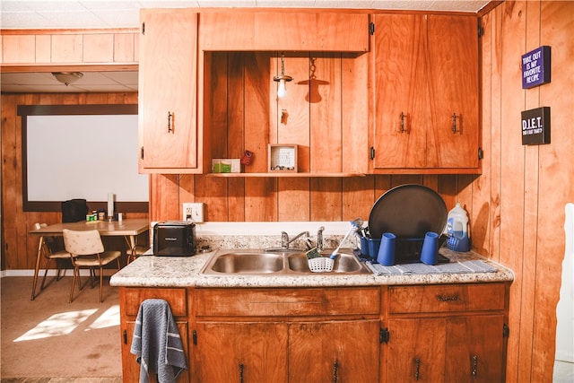 212 Main St, Jamestown, PA 16134 - kitchen featuring wood walls, light countertops, and brown cabinetry