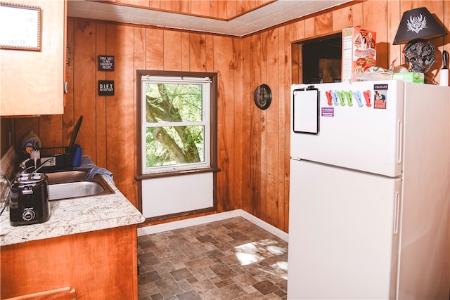 212 Main St, Jamestown, PA 16134 - kitchen featuring freestanding refrigerator, wood walls, stone finish flooring, and light countertops