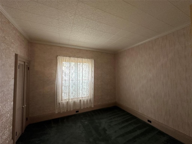 carpeted spare room with crown molding