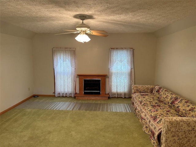 unfurnished living room featuring light carpet, a textured ceiling, vaulted ceiling, ceiling fan, and a healthy amount of sunlight