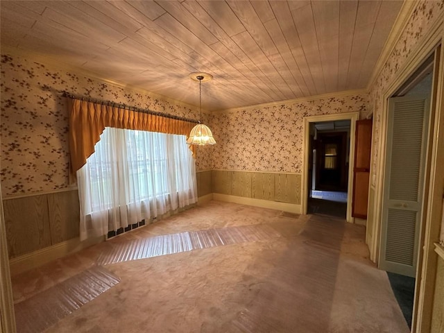 interior space featuring carpet flooring, ornamental molding, wooden ceiling, and a notable chandelier