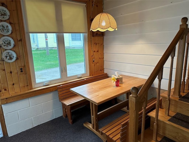 dining space with wood walls