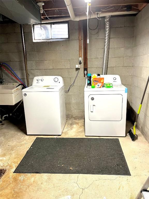 washroom featuring washer and clothes dryer and sink