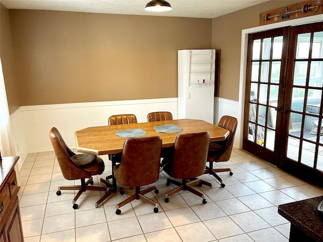 tiled dining area featuring french doors