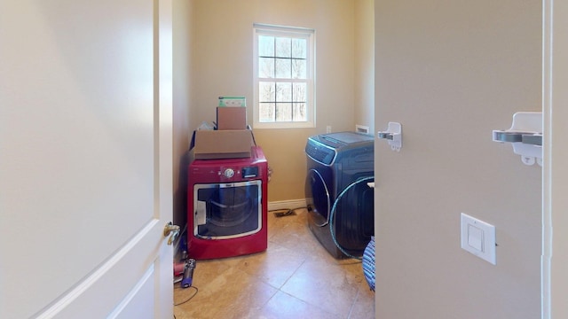 laundry room featuring washer and clothes dryer, tile patterned flooring, and laundry area