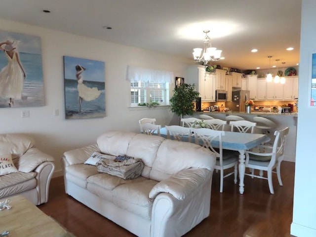 living room with a chandelier and dark hardwood / wood-style flooring