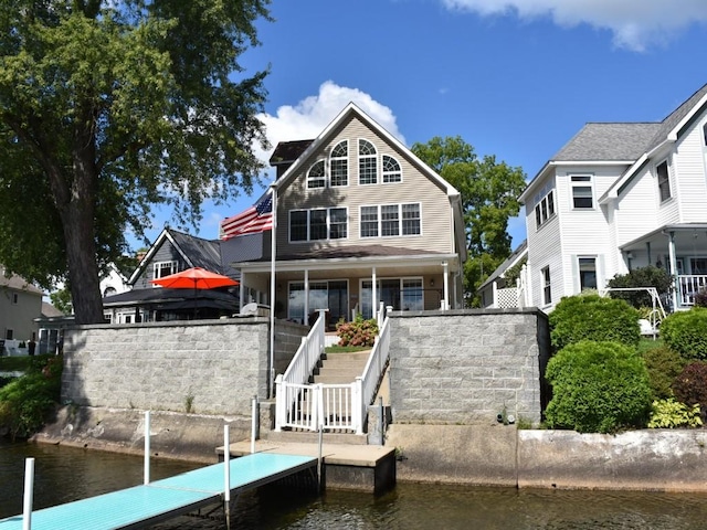 rear view of house featuring a water view