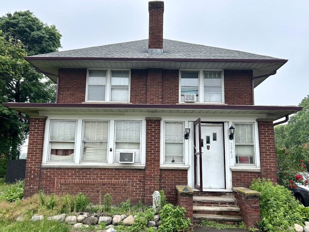 3942 W Ridge Rd, Erie, PA 16506 - american foursquare style home with a chimney, brick siding, and cooling unit