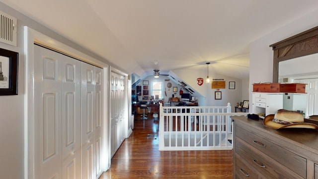 hallway with dark hardwood / wood-style flooring and lofted ceiling