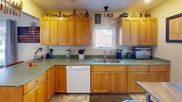 kitchen featuring white dishwasher, light tile patterned flooring, and sink