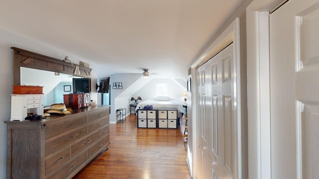 bedroom with hardwood / wood-style flooring and lofted ceiling