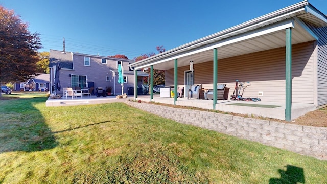 rear view of house featuring a lawn and a patio