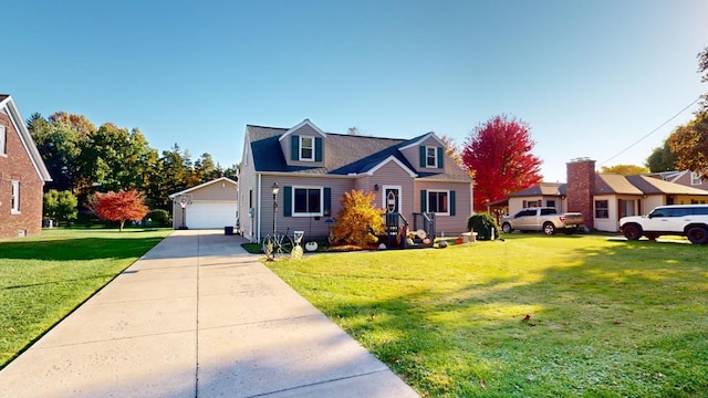 cape cod-style house featuring a garage, an outdoor structure, and a front yard