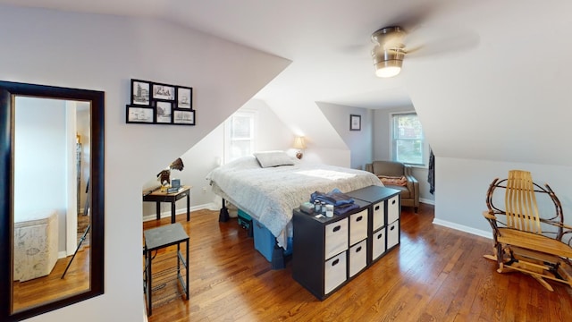 bedroom featuring ceiling fan, lofted ceiling, and hardwood / wood-style flooring