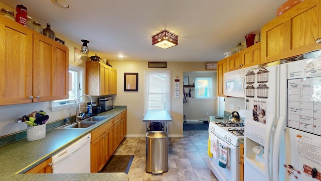 kitchen featuring white appliances and sink