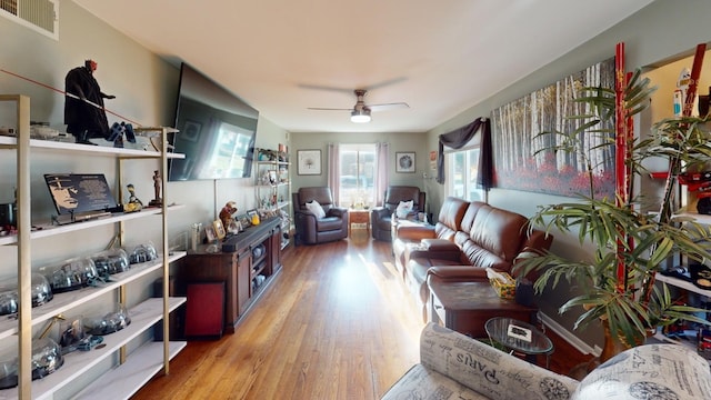 living room with light hardwood / wood-style floors and ceiling fan