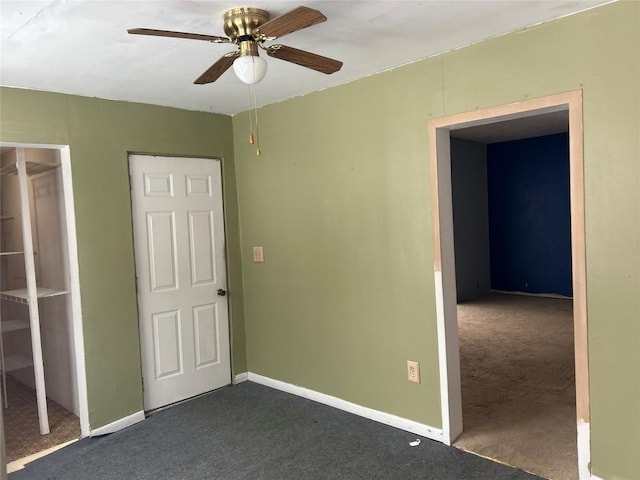 unfurnished bedroom featuring ceiling fan, a closet, dark carpet, and baseboards