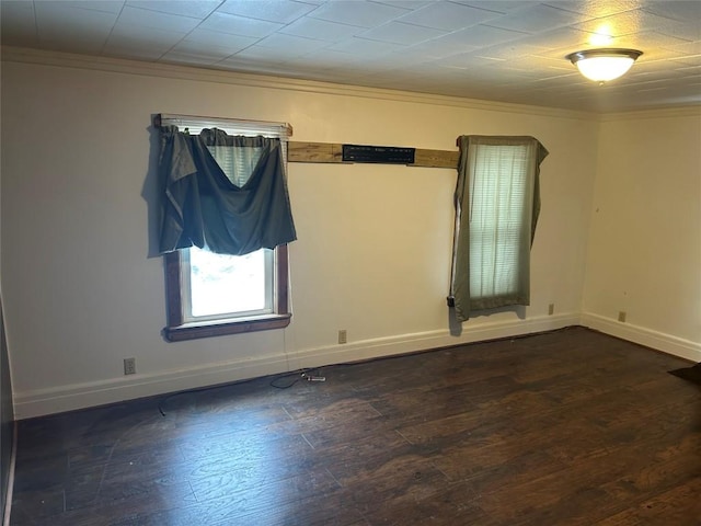 unfurnished room with baseboards, dark wood finished floors, and crown molding