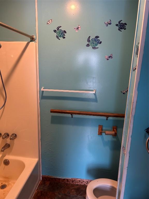 bathroom with shower / tub combination and toilet