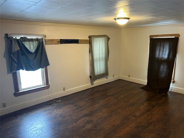 unfurnished room featuring dark wood-type flooring and baseboards