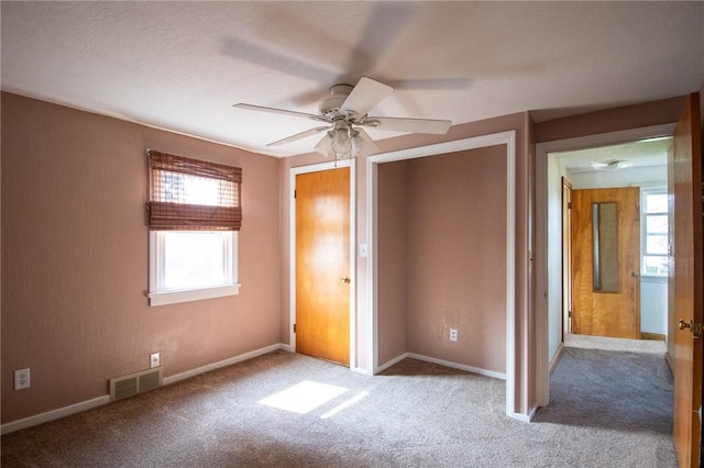 unfurnished bedroom with light colored carpet and ceiling fan