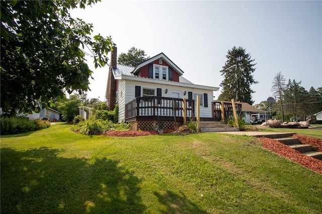 view of front of property featuring a front lawn and a wooden deck