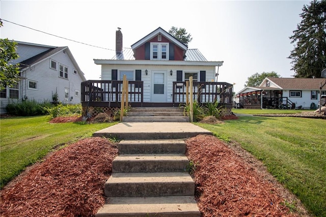 view of front facade featuring a front yard and a deck