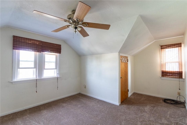 additional living space featuring ceiling fan, a healthy amount of sunlight, and lofted ceiling