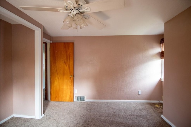 carpeted empty room with ceiling fan