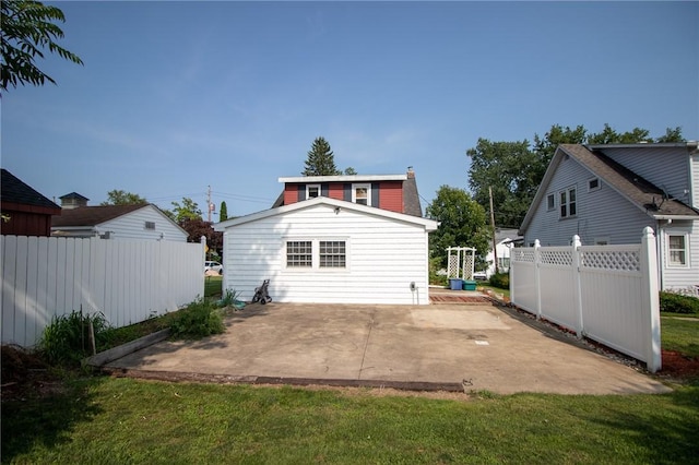 back of house featuring a yard and a patio