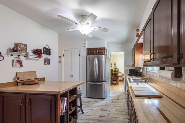 2548 E 32nd St, Erie, PA 16510 - kitchen featuring freestanding refrigerator, a ceiling fan, butcher block countertops, and dark brown cabinetry