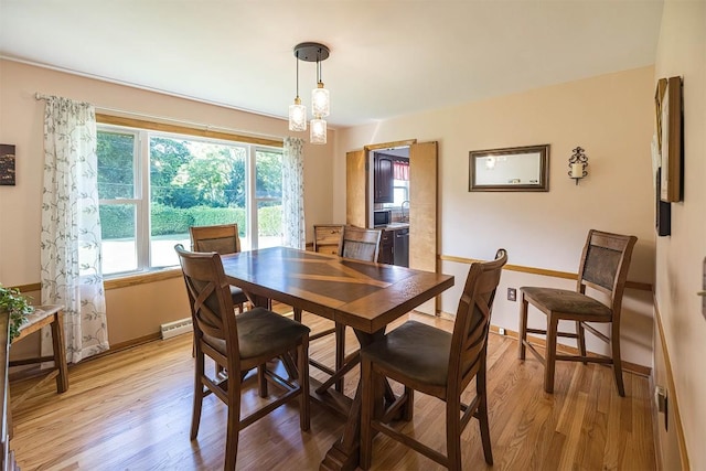 2548 E 32nd St, Erie, PA 16510 - dining space featuring light wood-style floors and a baseboard heating unit