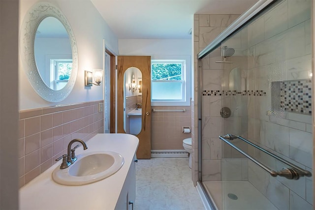 2548 E 32nd St, Erie, PA 16510 - bathroom with a baseboard heating unit, tile walls, a shower stall, vanity, and a wainscoted wall