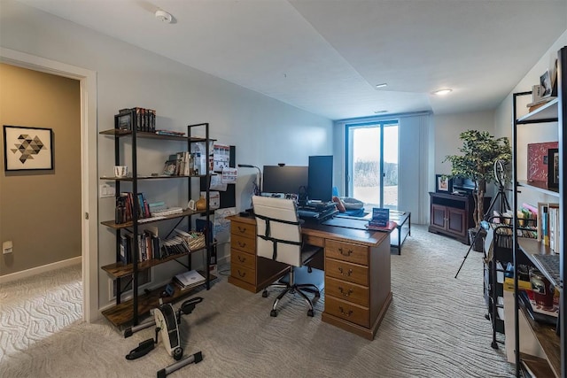 carpeted office featuring baseboards