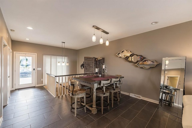 dining space featuring baseboards, visible vents, and recessed lighting