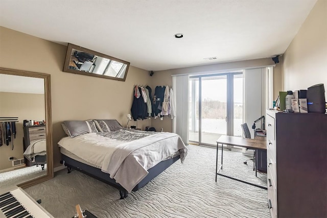 carpeted bedroom with access to outside and visible vents