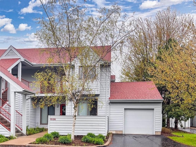 1036 Lookout Dr Unit 1036, Erie, PA 16507 - view of front of property featuring an attached garage, a shingled roof, aphalt driveway, and a balcony