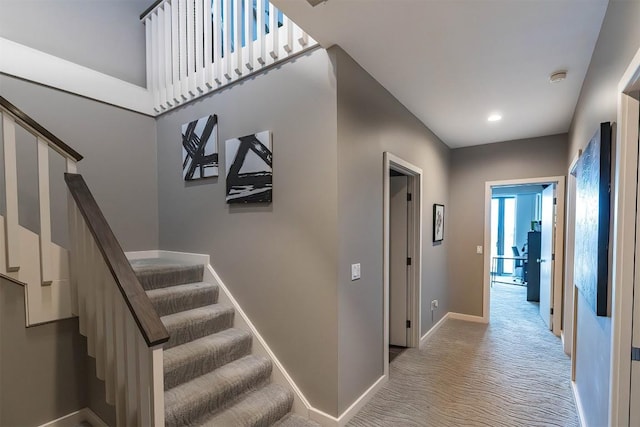 stairway with carpet, baseboards, and recessed lighting