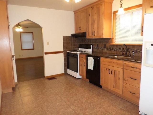 kitchen with sink, gas range oven, black dishwasher, pendant lighting, and white refrigerator with ice dispenser