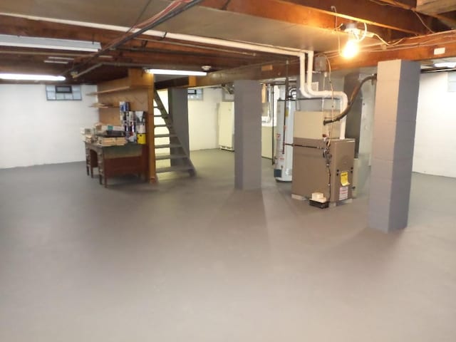 basement featuring heating unit and gas water heater