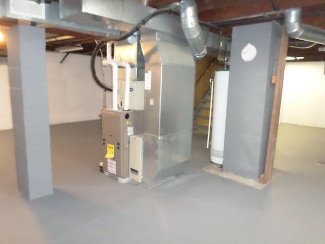 basement featuring heating unit and gas water heater